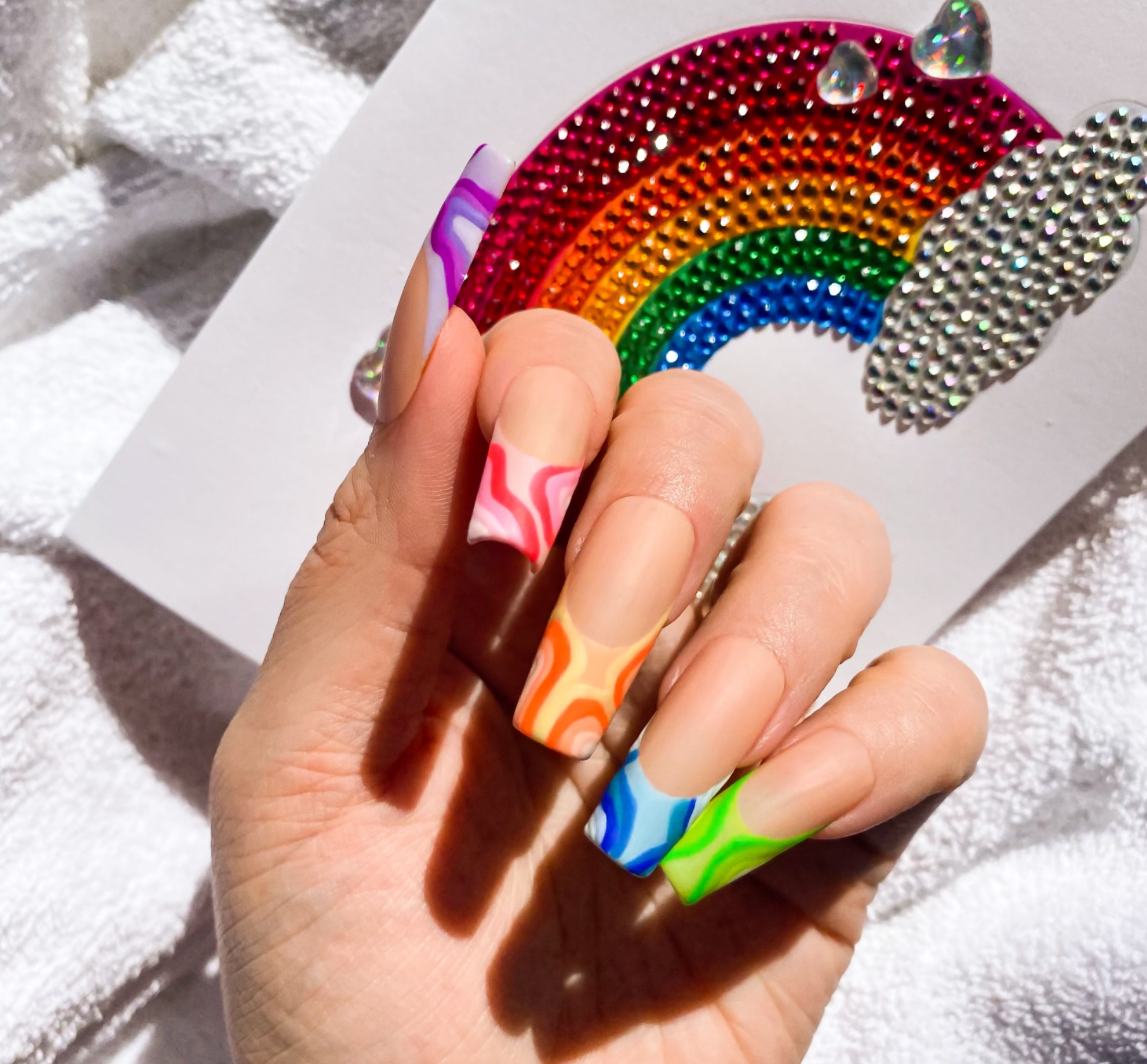 Make a bold statement with these stunning rainbow nails! Featuring a long square length and matte finish, they're the perfect way to showcase your colorful style.